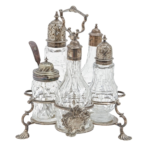 499 - A George III rococo silver cruet frame, the handle centred by a shell, the gallery applied with asym... 