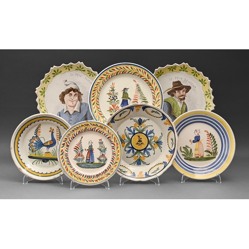 566 - Seven French faience plates, 19th c and later, painted with figures, flowers and a peacock, 25cm dia... 