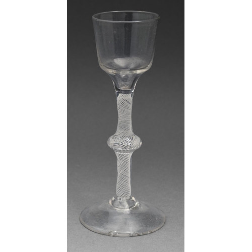 577 - A cordial glass, c1770, the ogee bowl on multiple series opaque twist stem and conical foot, 16.5cm ... 