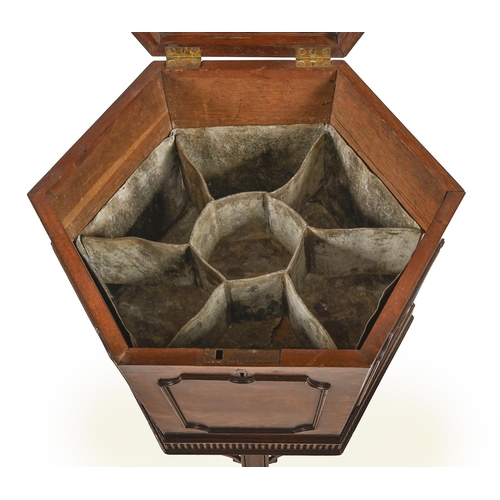 945 - A George III hexagonal mahogany wine cooler, the affixed stand with fluted border, on three moulded ... 