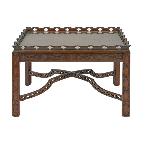 985 - An antique style carved mahogany occasional table, with pierced galleried top, base with fretwork X-... 