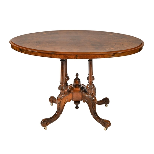 989 - A Victorian walnut inlaid loo table, the quarter-veneered top on four turned reeded pillars and carv... 