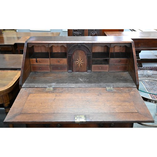 1016 - A George III oak bureau, inlaid and crossbanded with mahogany, on bracket feet, 107cm h; 94 x 49cm... 