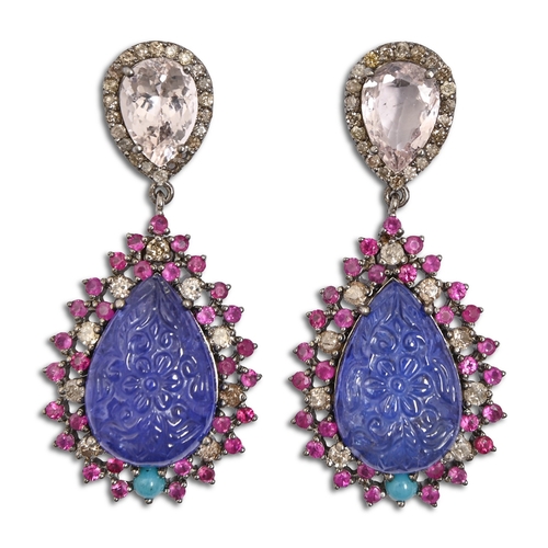 156 - A pair of multi gem earrings, the pear-shaped drop of carved tanzanite, with ruby and diamond surrou... 