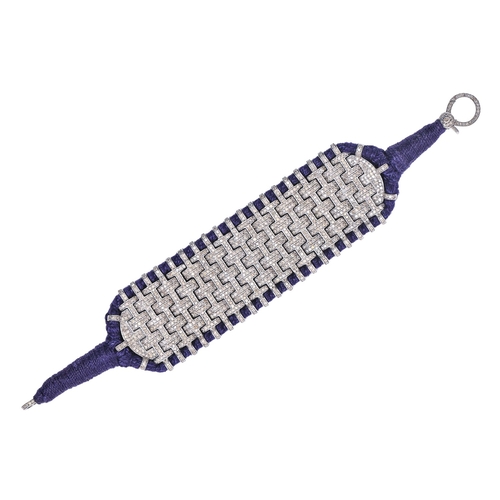 167 - A diamond and plaited blue wool-backed bracelet, in interlocking design, with diamond clasp, 20cm l... 