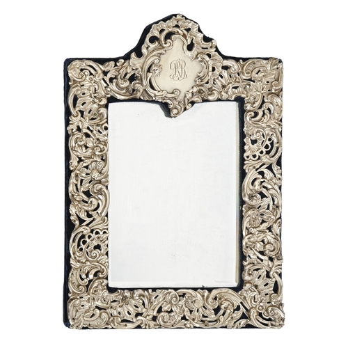 316 - A George V silver mirror, the mount die stamped with C scrolls and foliage, 34cm h, by Henry Matthew... 