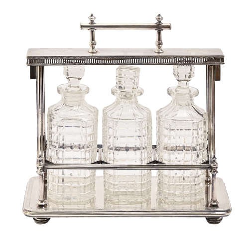 333 - An EPNS tantalus, early 20th c, the base with impressed maker's marks, G T & Co E P Patent, with... 