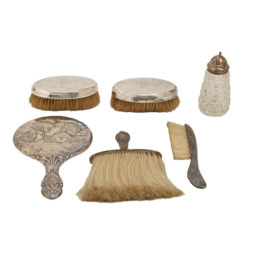 336 - A pair of silver mounted hairbrushes, London 1904, a silver repoussé hand mirror, Birmingham 1905, t... 