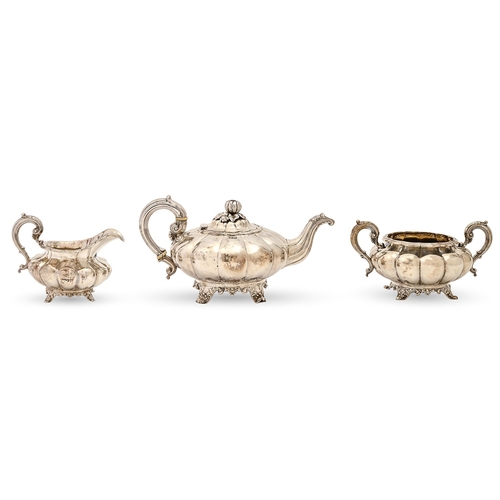 307 - A William IV silver composed tea service, of melon shape, the teapot with naturalistic melon knop, i... 