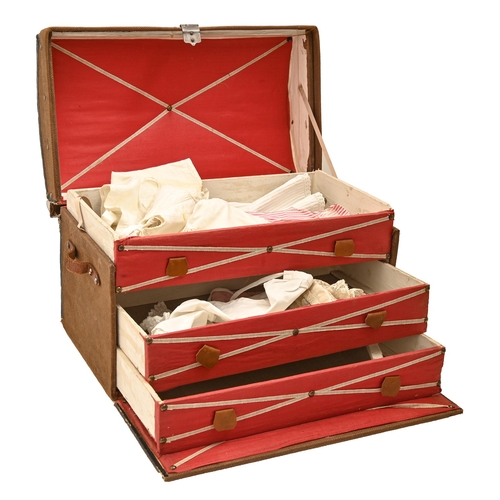 596 - A doll's cloth covered pine travelling trunk, c1930, with leather handles, the fitted interior with ... 