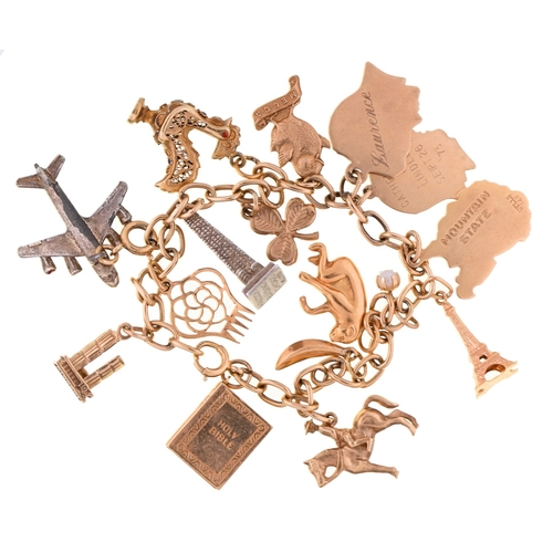 112 - A gold charm bracelet, 18cm l, bracelet and most of the charms marked 14K, 36.5g (including two base... 