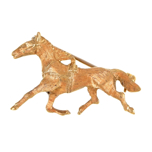 116 - An Italian gold cantering horse brooch, 33mm l, control mark and 750, 4.6g