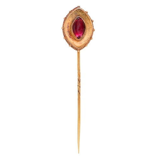 14 - A Victorian gold stickpin, with navette shaped foiled red paste terminal, the pin of gold, head 23mm... 