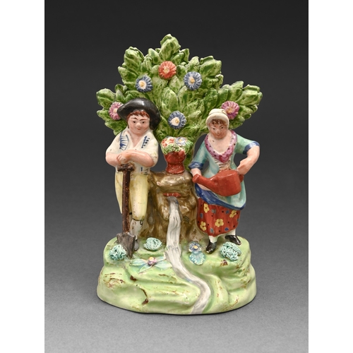 294 - A Staffordshire pearlware group of two gardeners, c1820, before bocage, painted in overglaze enamels... 