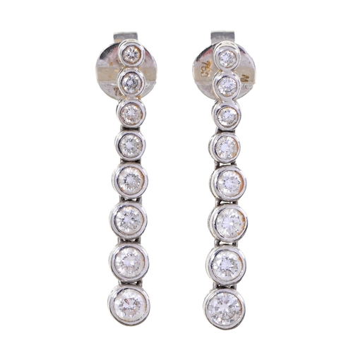 30 - A pair of diamond earrings, with eight graduated collets in line and fully articulated, in 18ct whit... 
