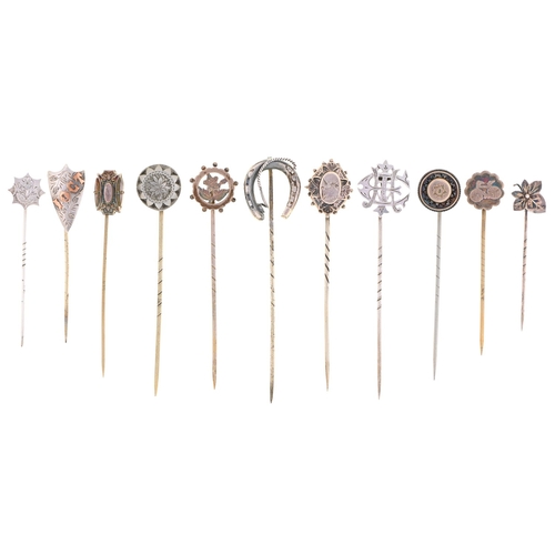 4 - Eleven Victorian stickpins, mostly of silver, the head of one engraved with a contemporary veteran b... 