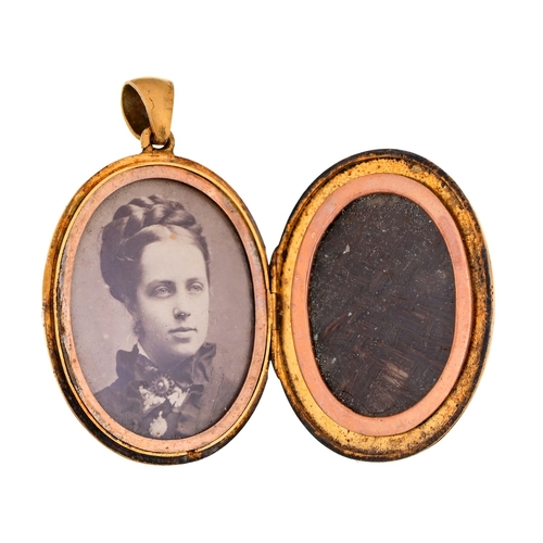 55 - A Victorian gold mourning locket, containing a lock of hair and contemporary photograph, oval 31mm, ... 