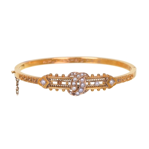 62 - A Victorian split pearl and gold bangle, engraved W H and C B Sept 8th 1891, 57mm (internal), marked... 