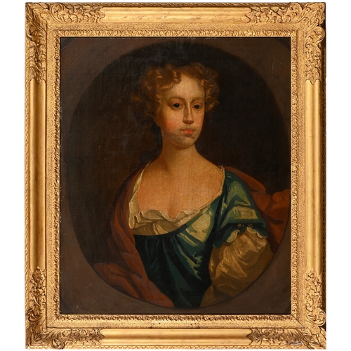 645 - Follower of Sir Godfrey Kneller - Portrait of a Lady, bust length in a blue dress with pearls, feign... 
