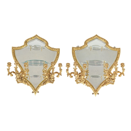 697 - A pair of giltwood girandoles, 20th c, shield shaped with six candle branches and three glass shelve... 