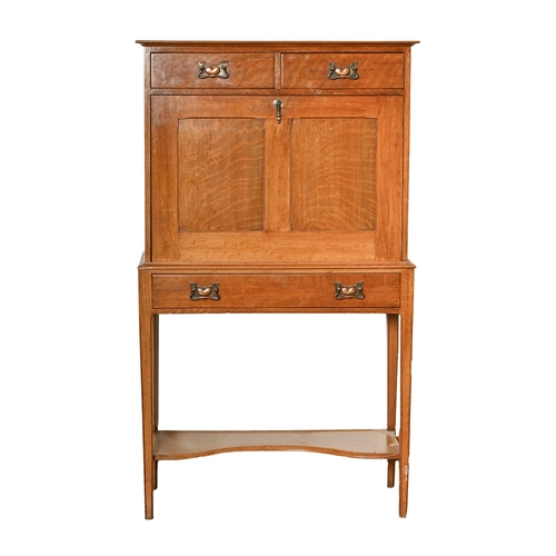 700 - An Arts and Crafts oak secretaire, with fall front, on square tapering legs with undertier, 137cm h;... 