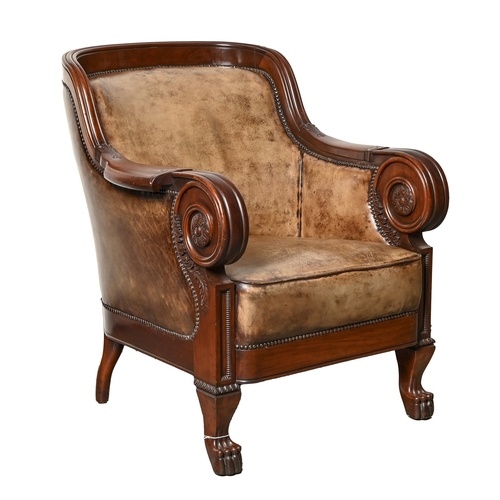 701 - A French mahogany bergere, late 19th c, with carved arms and rosettes, on paw feet, in close nailed ... 
