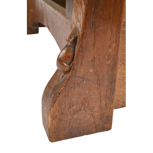 751 - Robert 'Mouseman' Thompson. An oak adjustable armchair, c1930s, with leather webbed seat, over-scrol... 