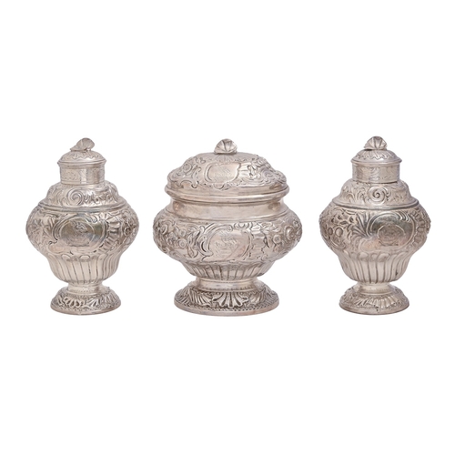 185 - A pair of George II Rococo silver tea caddies and sugar box,&nbsp;the ogee caddies and oval ogee box... 