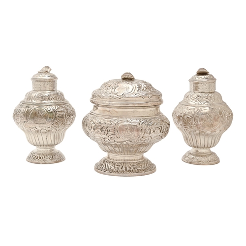 185 - A pair of George II Rococo silver tea caddies and sugar box,&nbsp;the ogee caddies and oval ogee box... 