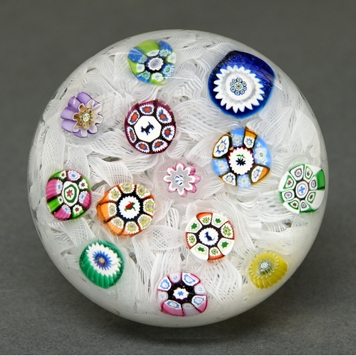 328 - A Perthshire Baccarat-type upset muslin ground glass paperweight, 1979, with animal silhouette canes... 