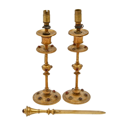 456 - A pair of Victorian engraved and lacquered gilt brass candlesticks and a letter knife en suite, stud... 