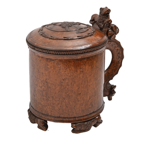 457 - A Norwegian burr birch peg tankard, dated 1780, of fine colour and patina, with carved lion lid, thu... 