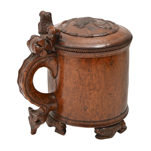 457 - A Norwegian burr birch peg tankard, dated 1780, of fine colour and patina, with carved lion lid, thu... 