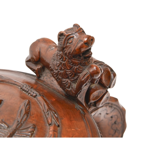 457 - A Norwegian burr birch peg tankard, dated 1780, of fine colour and patina, with carved lion lid, thu... 