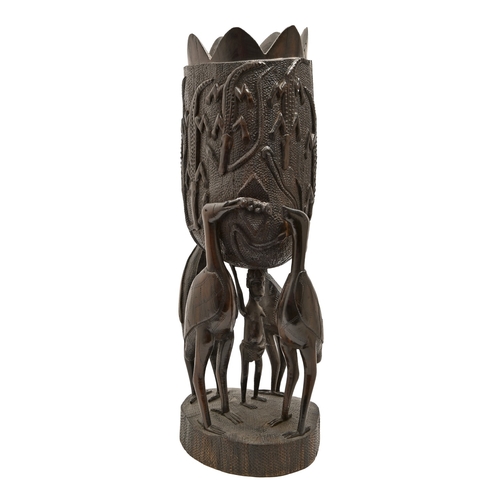 495 - An African carved ebony jardiniere, 20th c, 67cm h