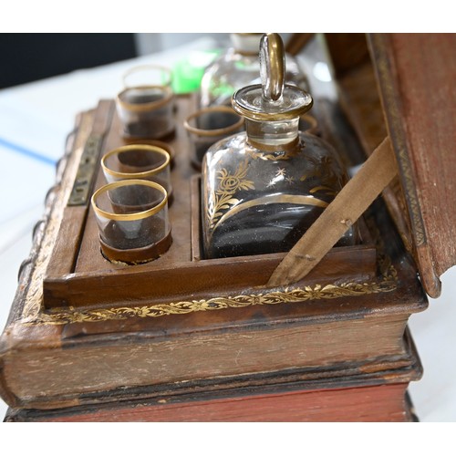 541 - A French liqueur set, the case formed from antique French gilt tooled leather bound books, with a pa... 
