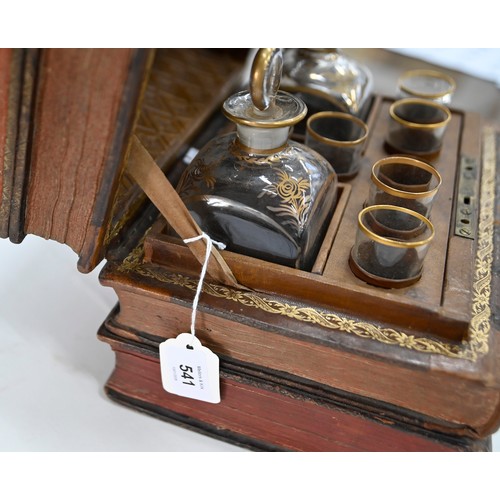 541 - A French liqueur set, the case formed from antique French gilt tooled leather bound books, with a pa... 