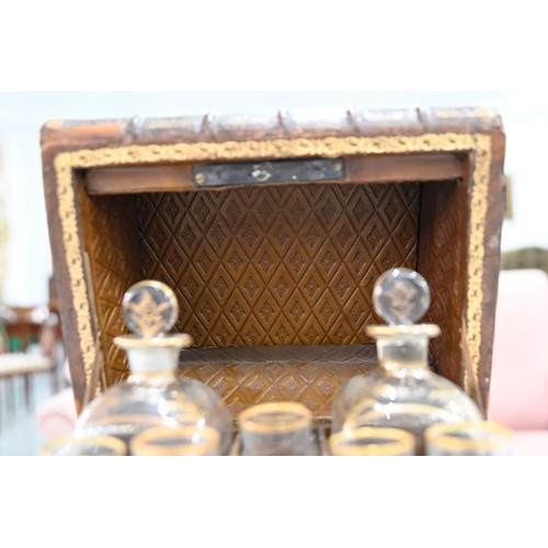 541 - A French liqueur set, the case formed from antique French gilt tooled leather bound books, with a pa... 