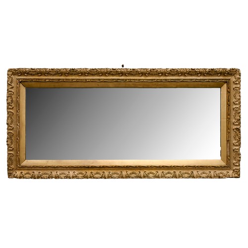 312 - A giltwood and composition mirror, early 20th c, 103 x 48cm
