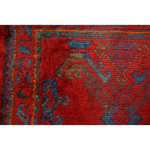 162 - A Turkish Ushak tomato red long rug, early 20th c, 90 x 254cm