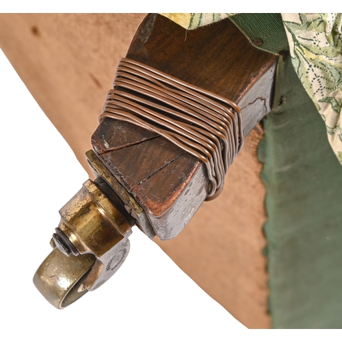 195 - A Victorian easy armchair, Howard of Berners Street, c1900 on turned or square walnut legswith brass... 