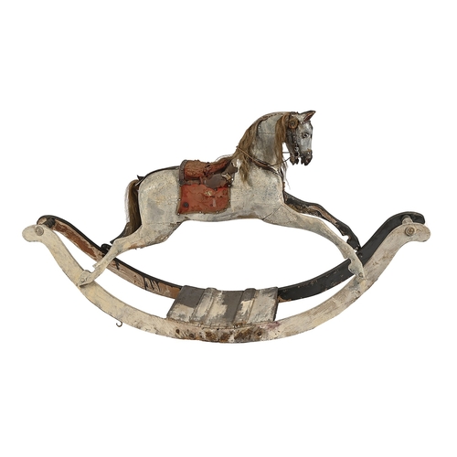 196 - An English carved wooden rocking horse, F H Ayres, early 20th c,  with head down in a 'racing' posit... 