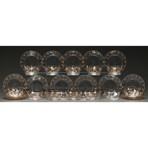 43 - A set of twelve Bohemian octagonal gilt glass finger bowls and sixteen saucers, c1910, with alternat... 