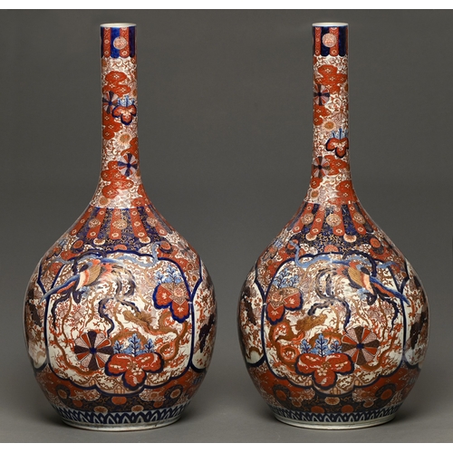 57 - A monumental pair of Japanese Imari vases, Meiji period, typically decorated and of bottle shape, 93... 