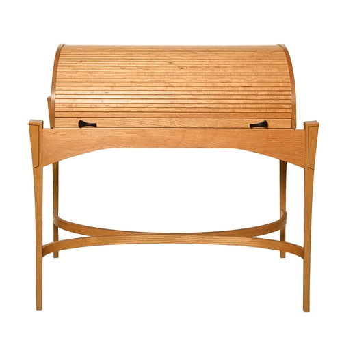 315 - A contemporary light wood and ebony writing table with tambour shutter, late 20th c, with fitted int... 