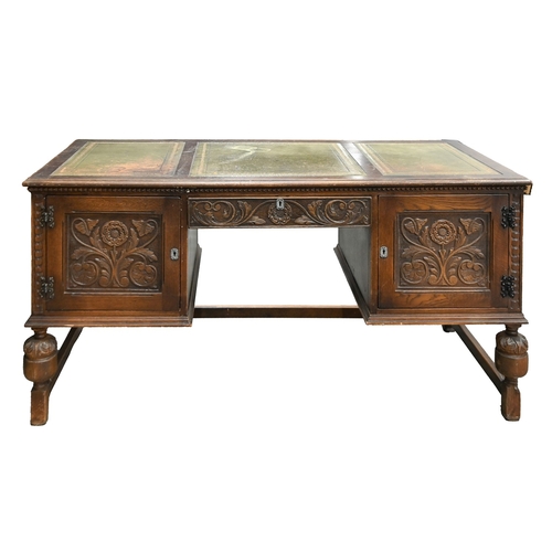 325 - An antique style carved oak desk, with tooled green leather, on bulbous legs and stretcher base, 76c... 