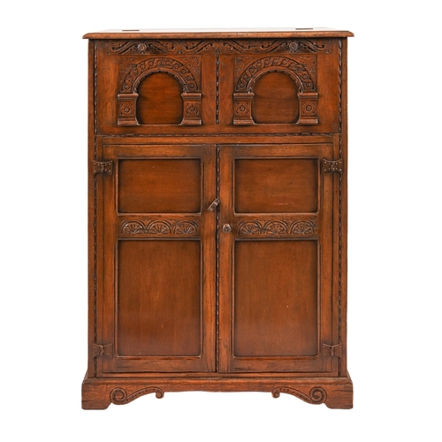352 - An antique style carved and panelled oak cocktail cabinet, 25cm h; 89 x 43cm