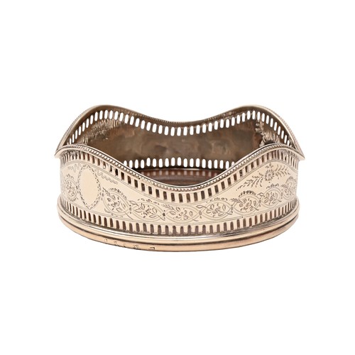 10 - A George III neo classical pierced and engraved silver wine coaster, with undulating beaded rim, ins... 