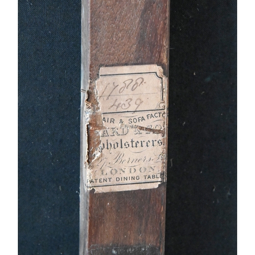 651 - Howard of Berners Street. A late Victorian couch, with scroll and bolster ends, in buttoned and bras... 