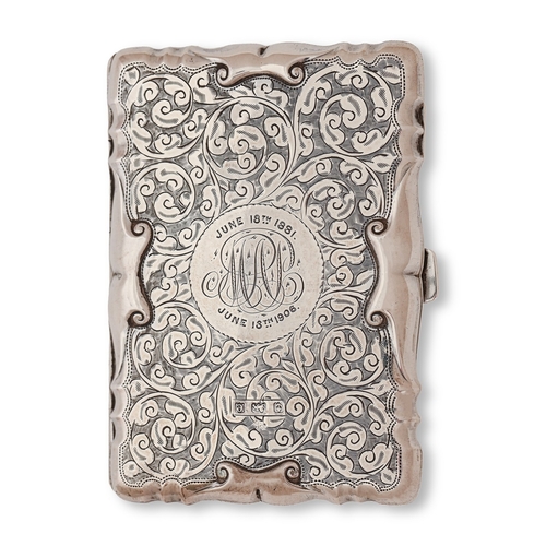 135 - An Edwardian silver card case, engraved with scrolling foliage in stamped paper scroll borders, line... 